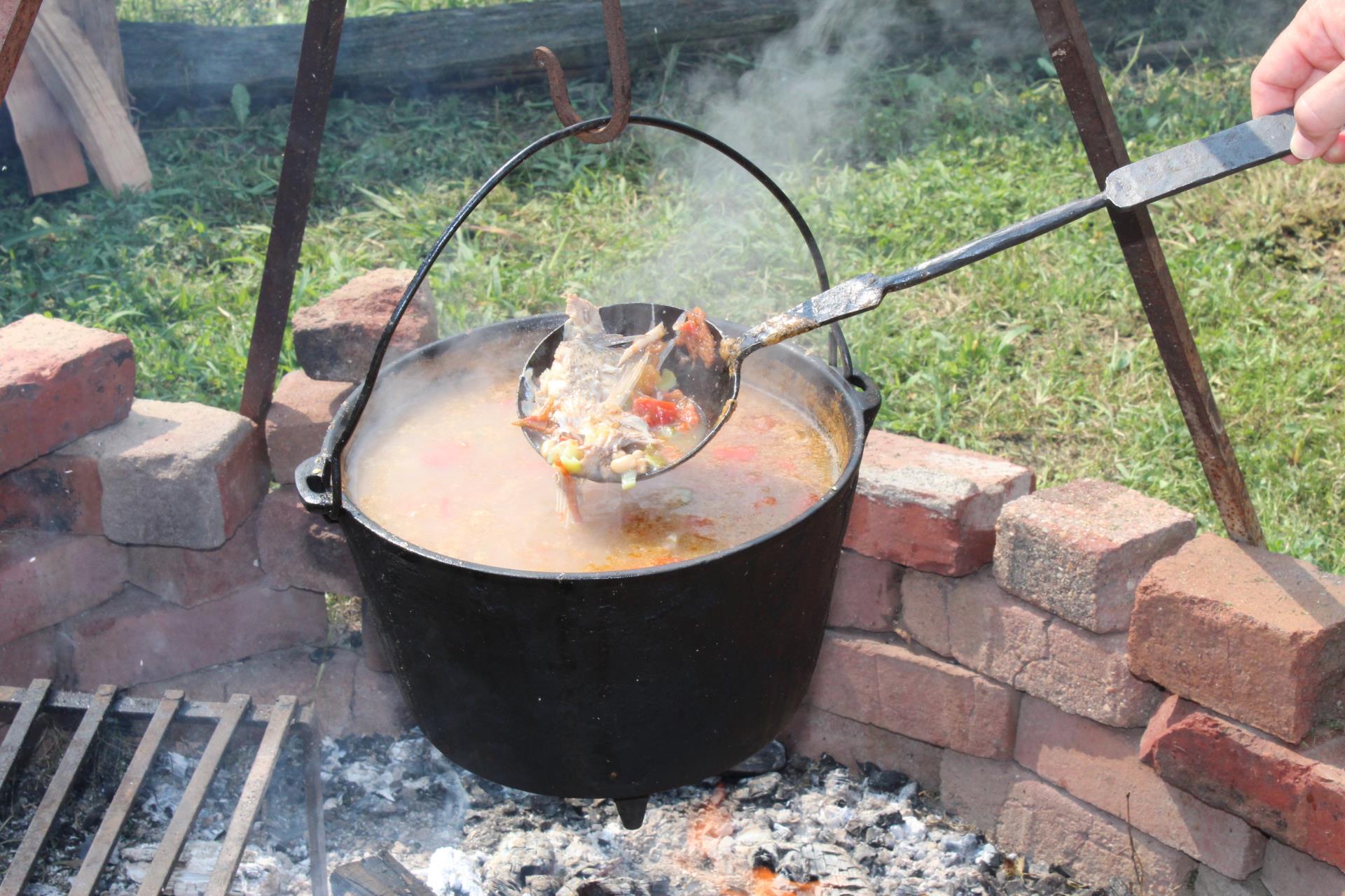 African dish cooking over open fire at Revolution-era farm