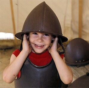A child trying on armor at James Fort