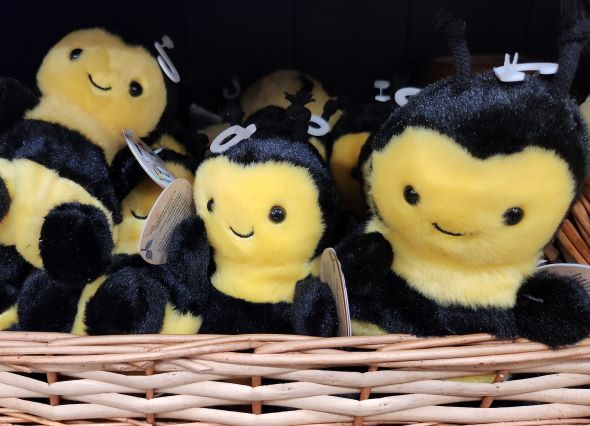 Honeybee plush toys in a basket