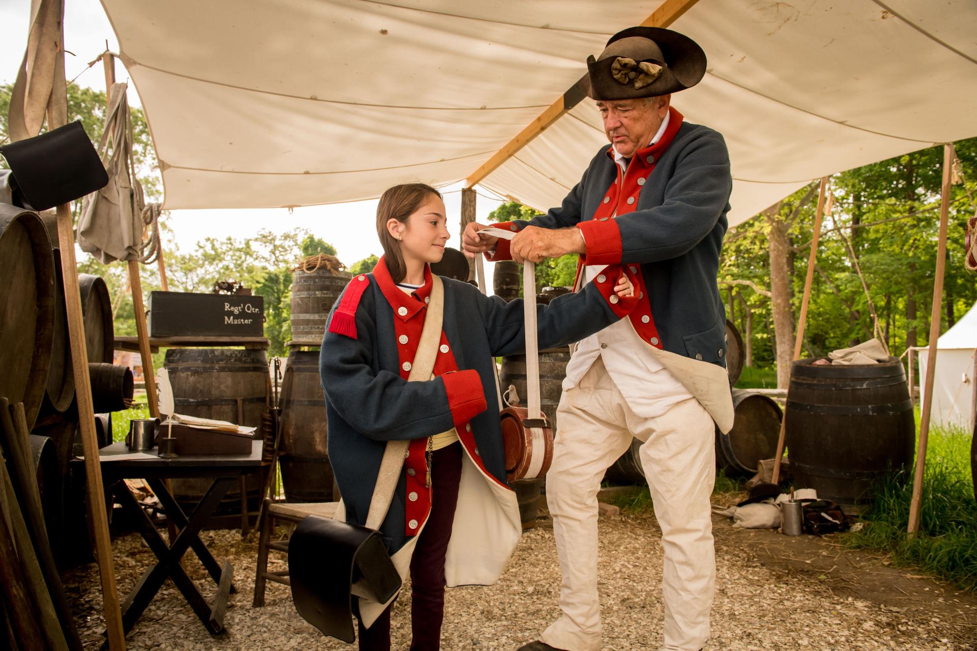 A girl tries on a Continental Army uniform at the American Revolution Museum at Yorktown